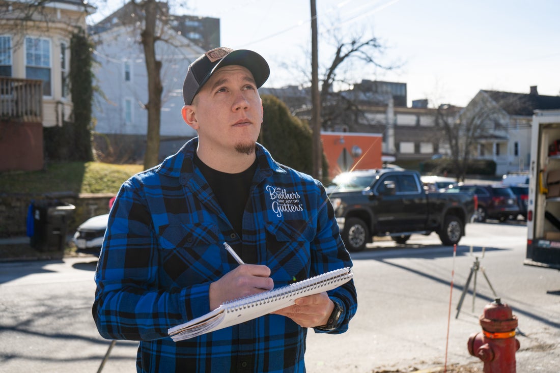 A Hudson Valley Solutionist writing up a gutter estimate