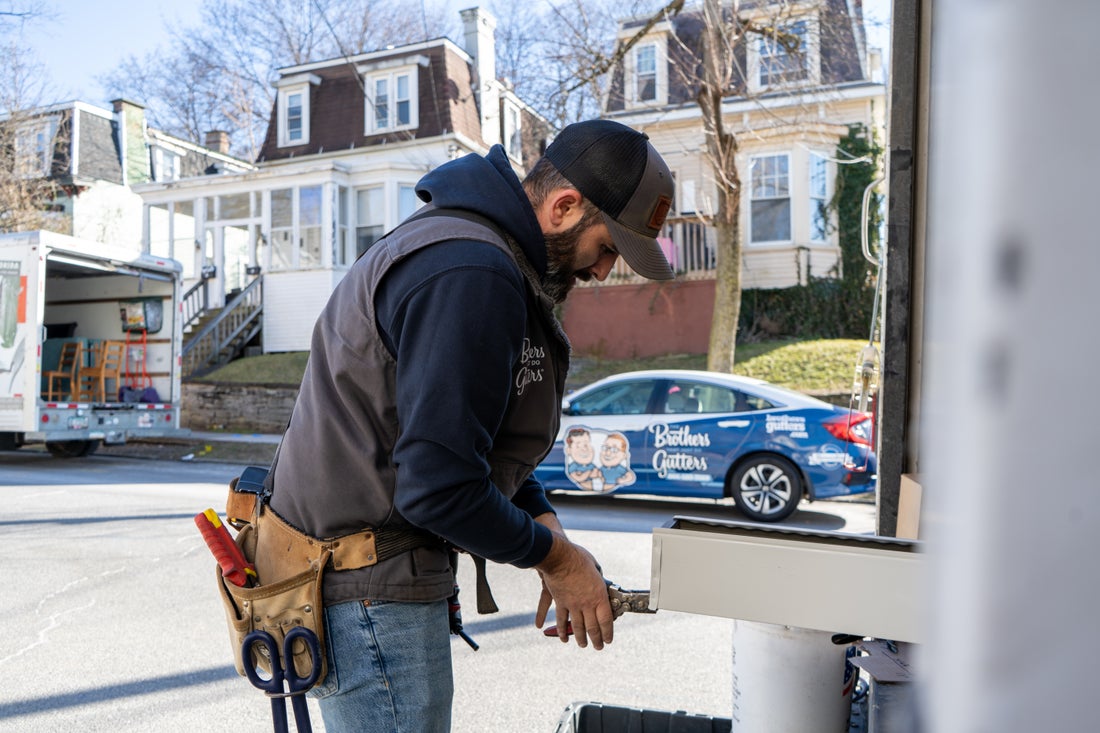 Cutting gutter stock at the truck on a Hudson Valley job